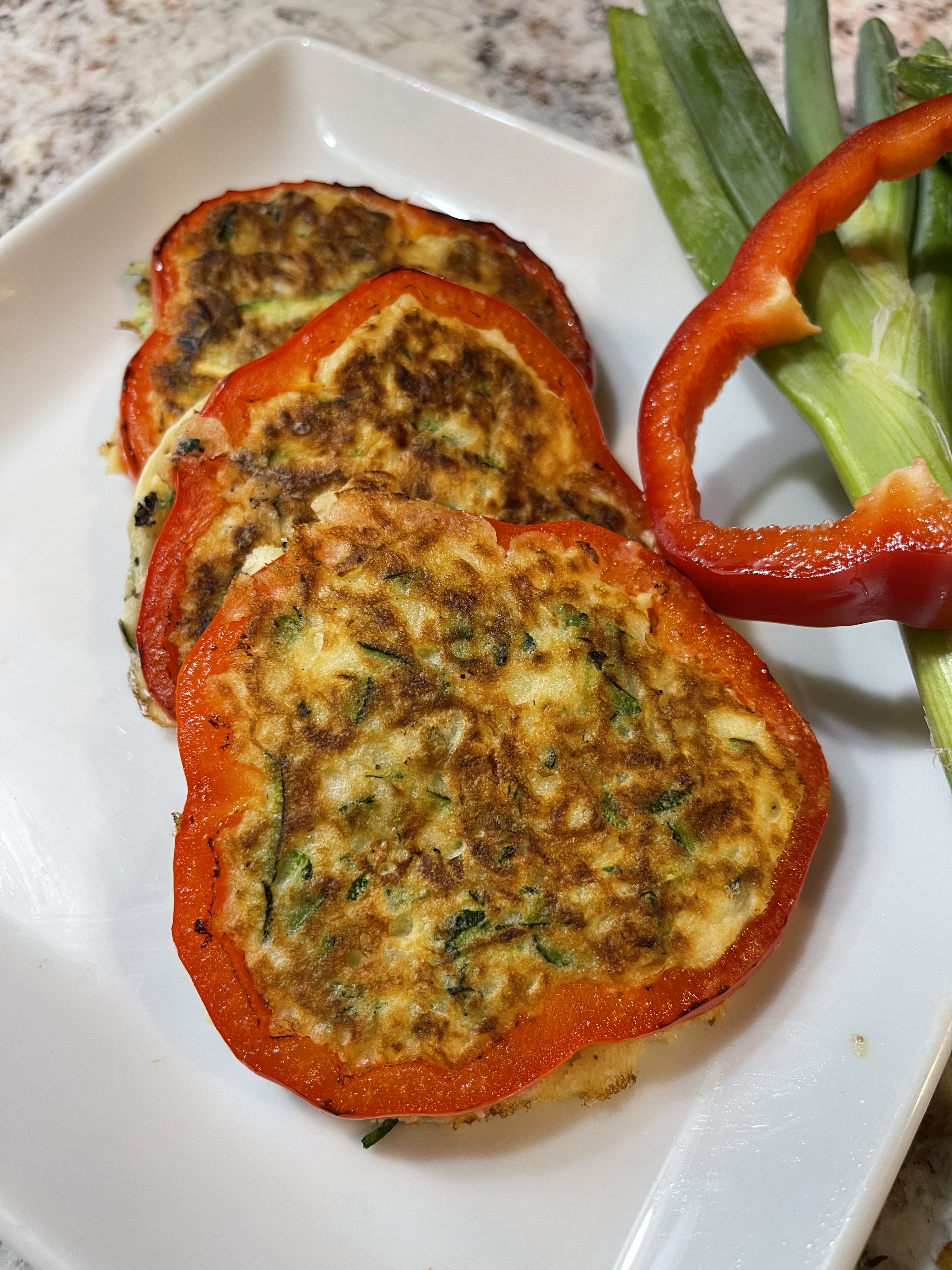 Golden-brown zucchini fritters served with a dollop of sour cream, perfect for beginner home cooks looking for a quick and easy veggie recipe.